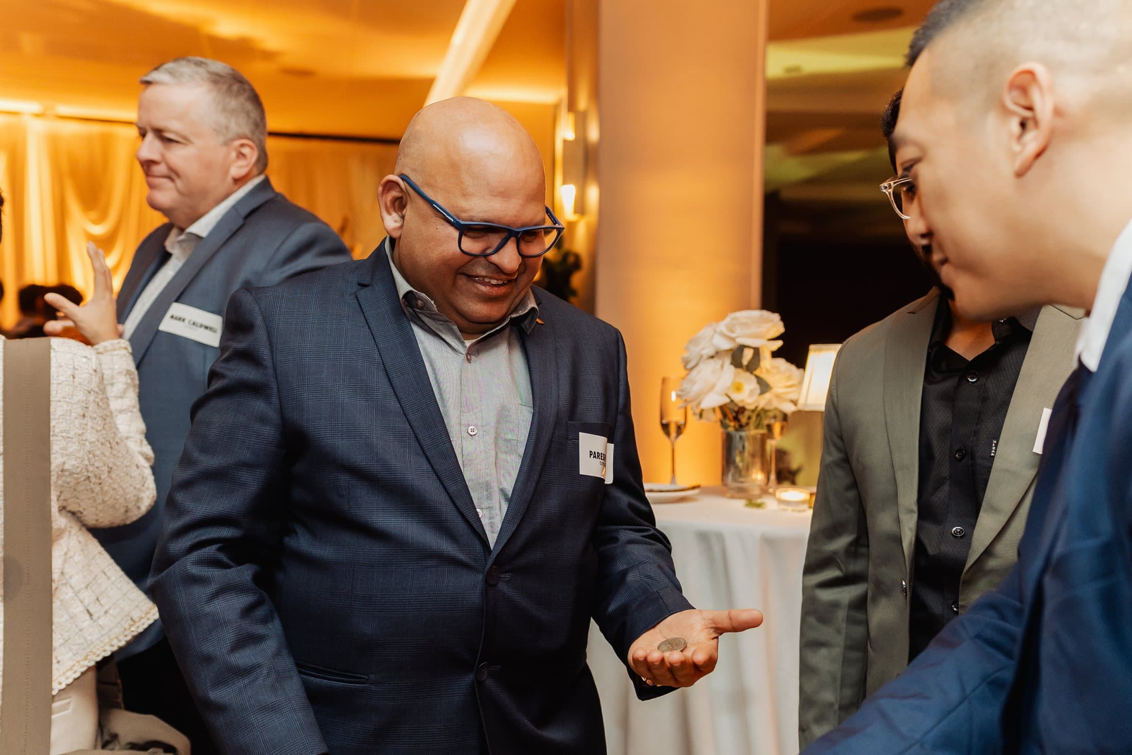 Corporate guest smiling in surprise during close-up magic