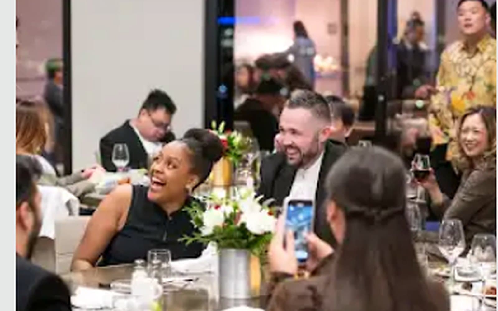John Ha performing an interactive stand-up magic show with a guest at a corporate dinner event