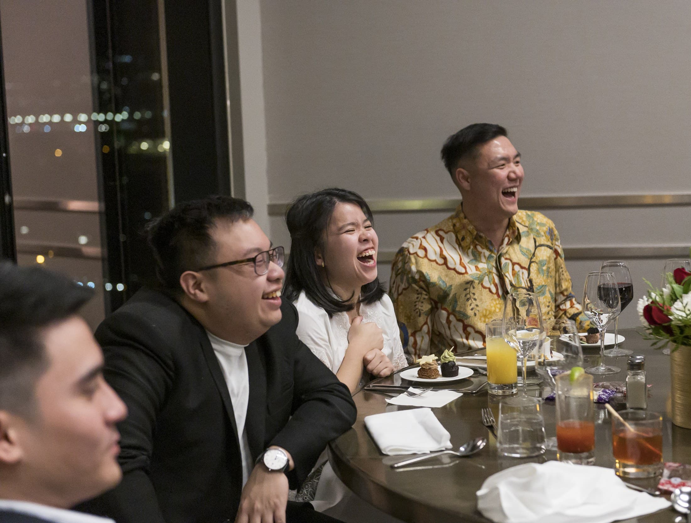 Guests laughing hard during close-up magic with John Ha