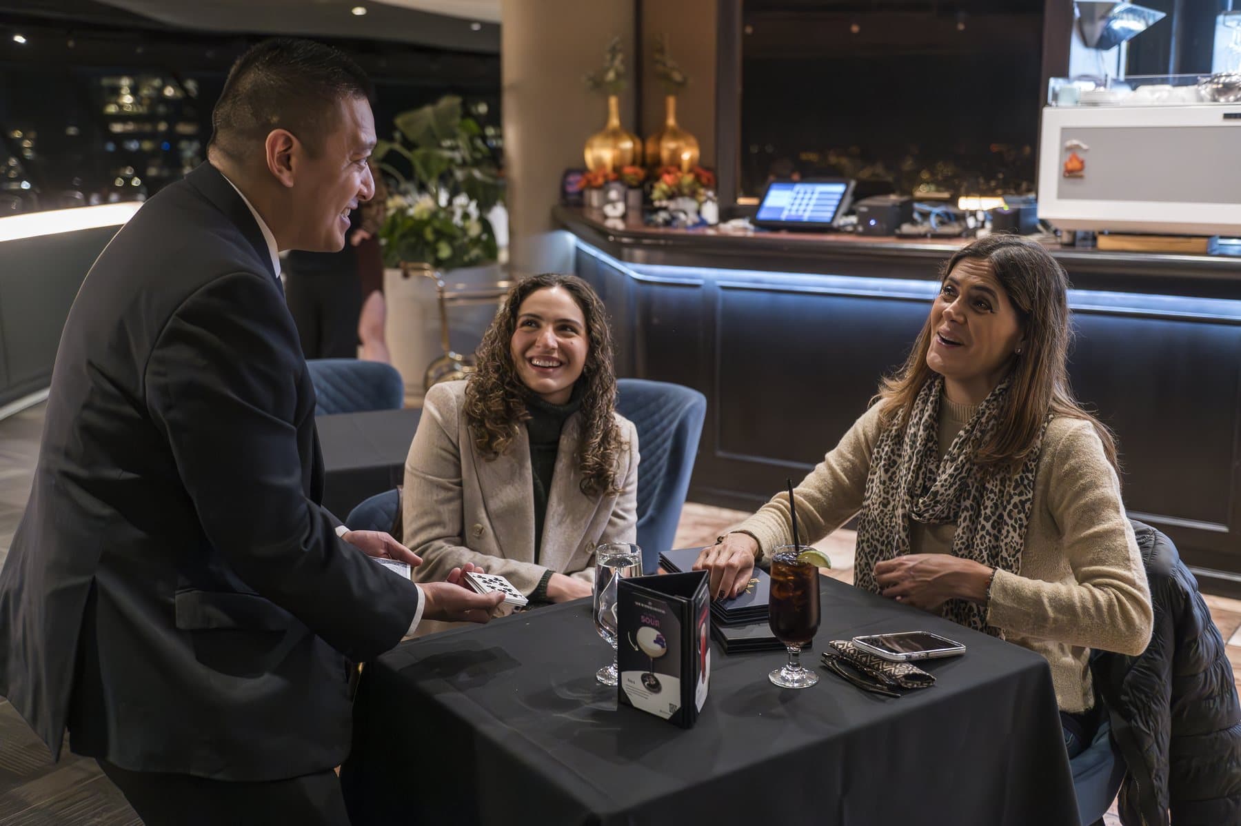 John Ha performing close-up magic for guests during an Ontario fundraiser reception