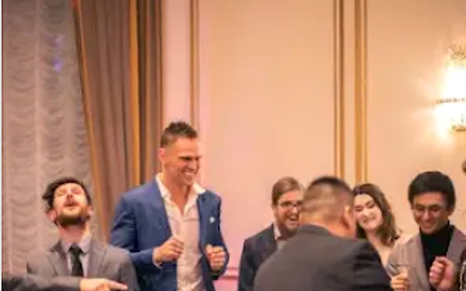 John Ha performing a stand-up magic show with Ontario company event guests reacting and laughing